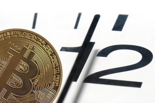 Bitcoin coin and clock 5 minutes before twelve