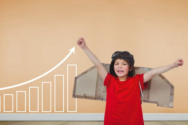 Child with cardboard wings against the background of a growing graph