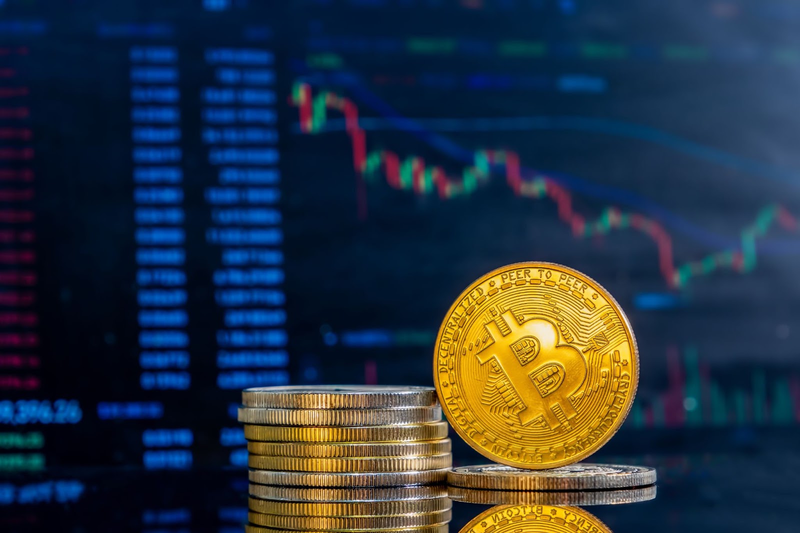 Closeup of golden bitcoins on background of decreasing crypto