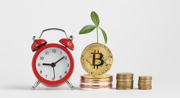 Bitcoin coin next to the alarm clock
