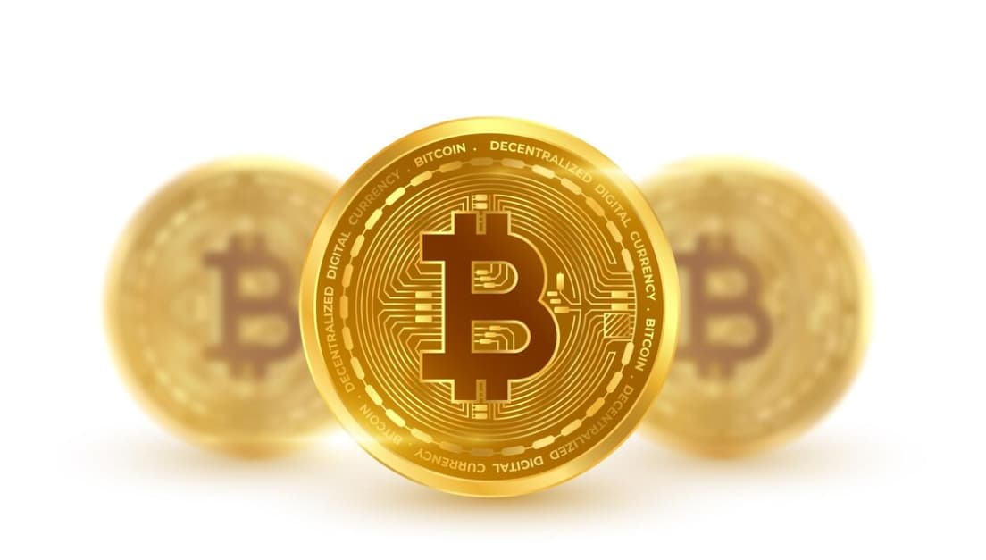 three bitcoins on white background, two of them are blurred behind