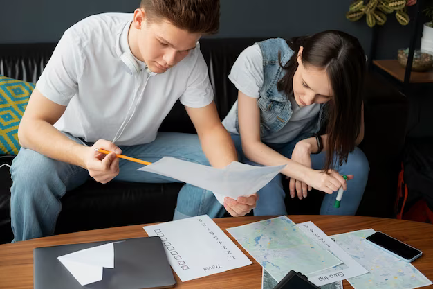 Teenagers sitting on the sofa and sorting through papers