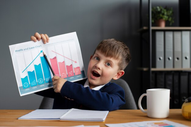 Boy showing chart at his desk
